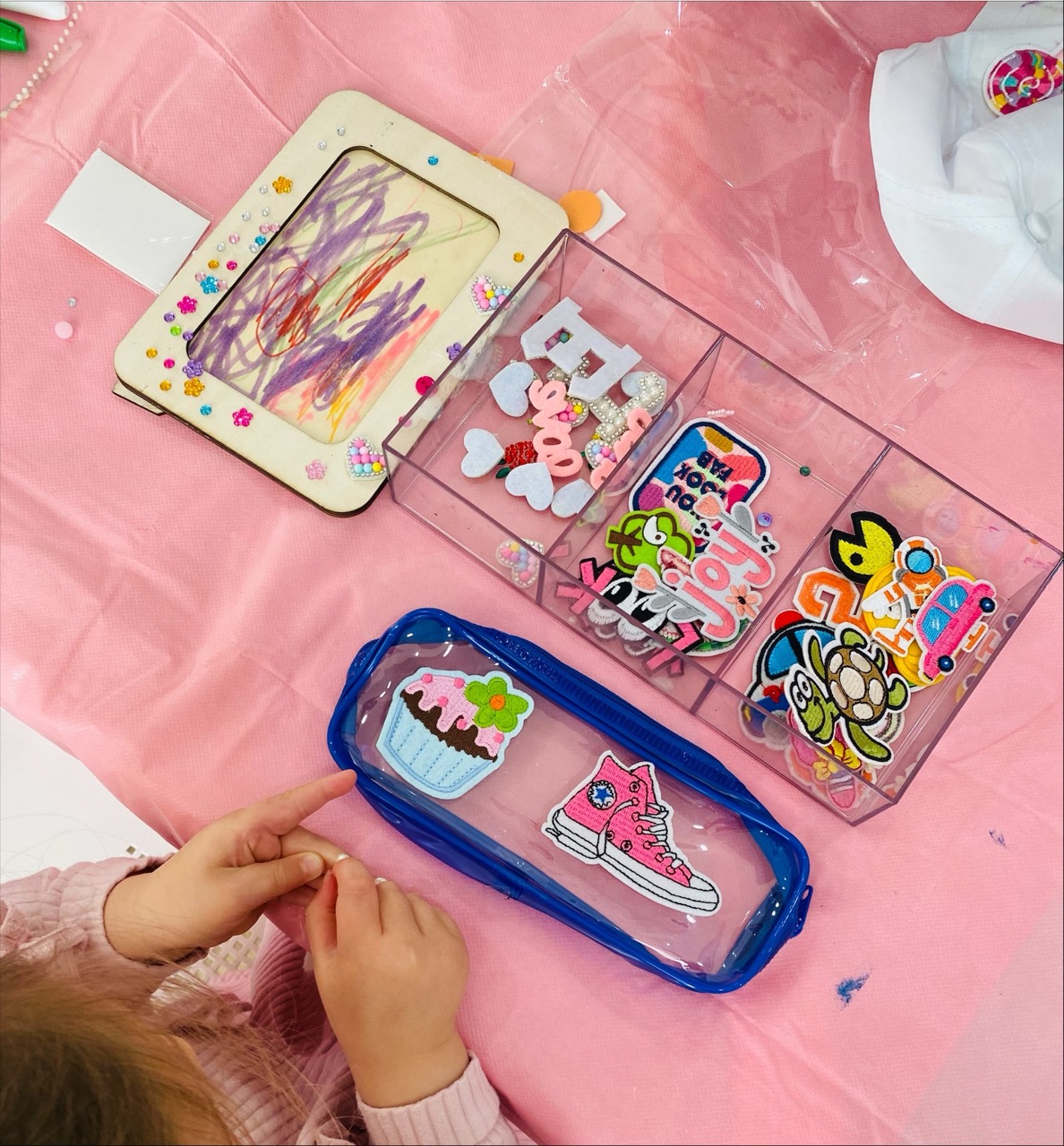 Child decorating a craft keepsake at a B.Curious Boutique Craft party
